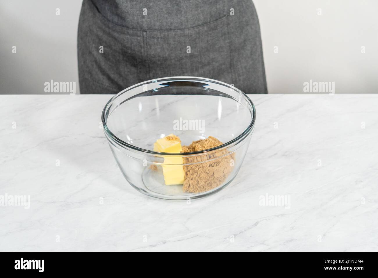 Mixing ingredients in a glass mixing bowl to bake chocolate graham