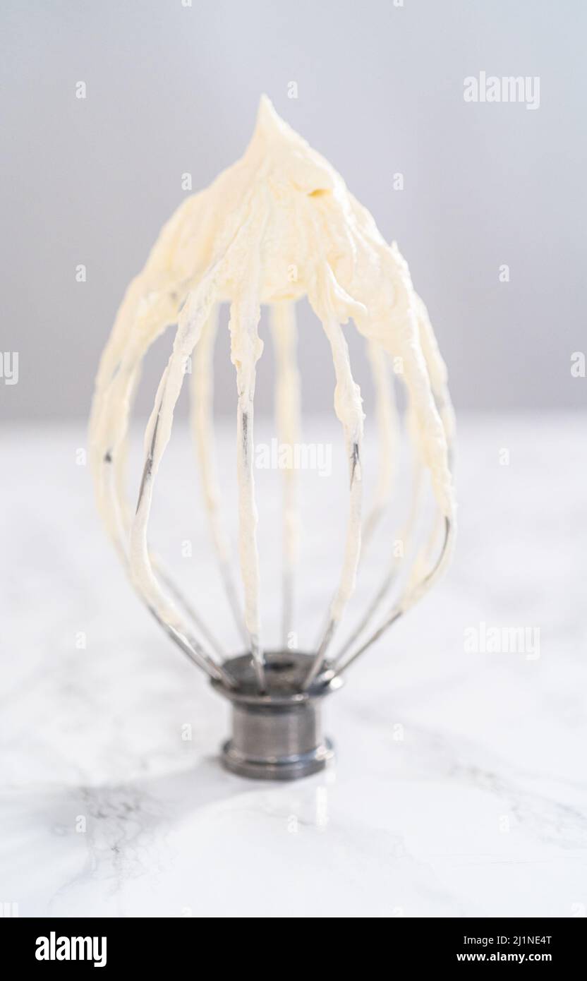 Whipping white ganache in kitchen mixer to make the white chocolate