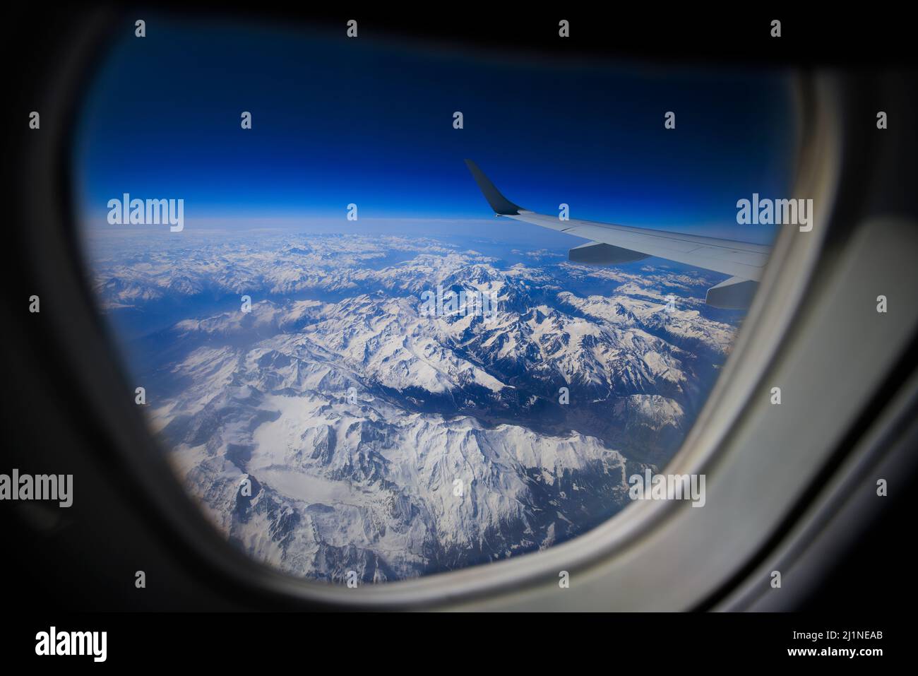 View of the Alps from the window of an Embraer 190SR BA CityFlyer plane. Stock Photo