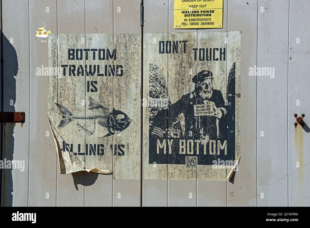 Fishermens anti bottom trawling posters survive on a door at Saltash in Cornwall Stock Photo
