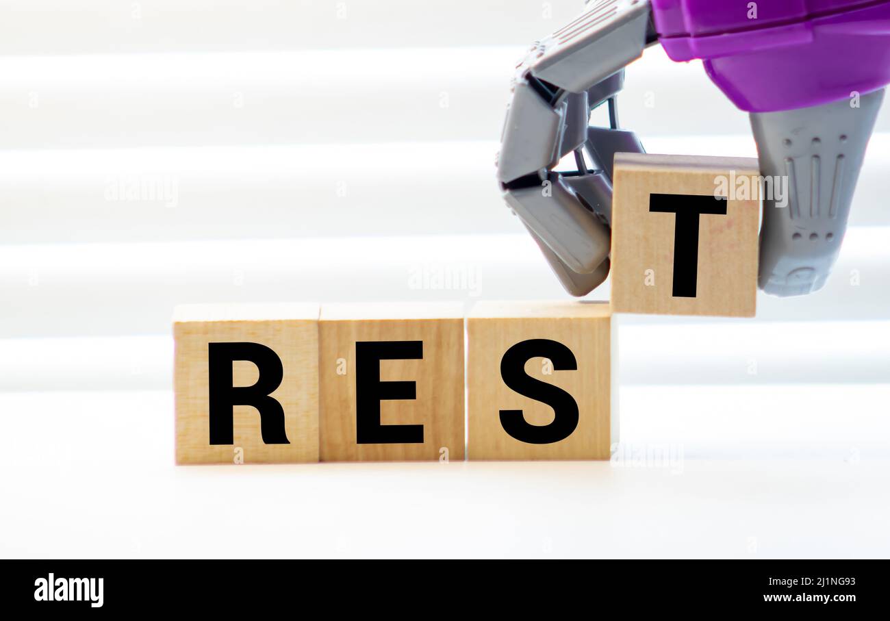 Rest word from wooden blocks on desk. Stock Photo