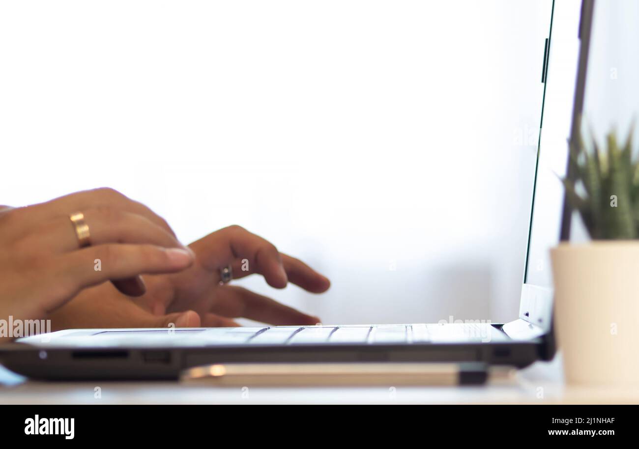 Mockup image of hand using laptop with blank white screen on vintage ...