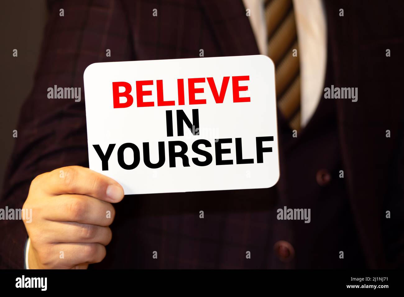 Believe In Yourself, written on an yellow sticky note on a cork