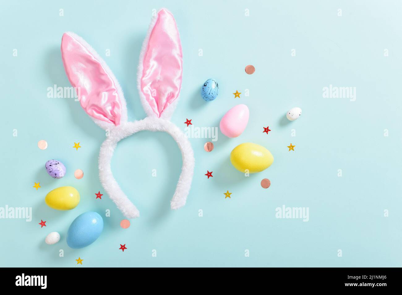 Background with rabbit ears and Easter eggs. Stock Photo