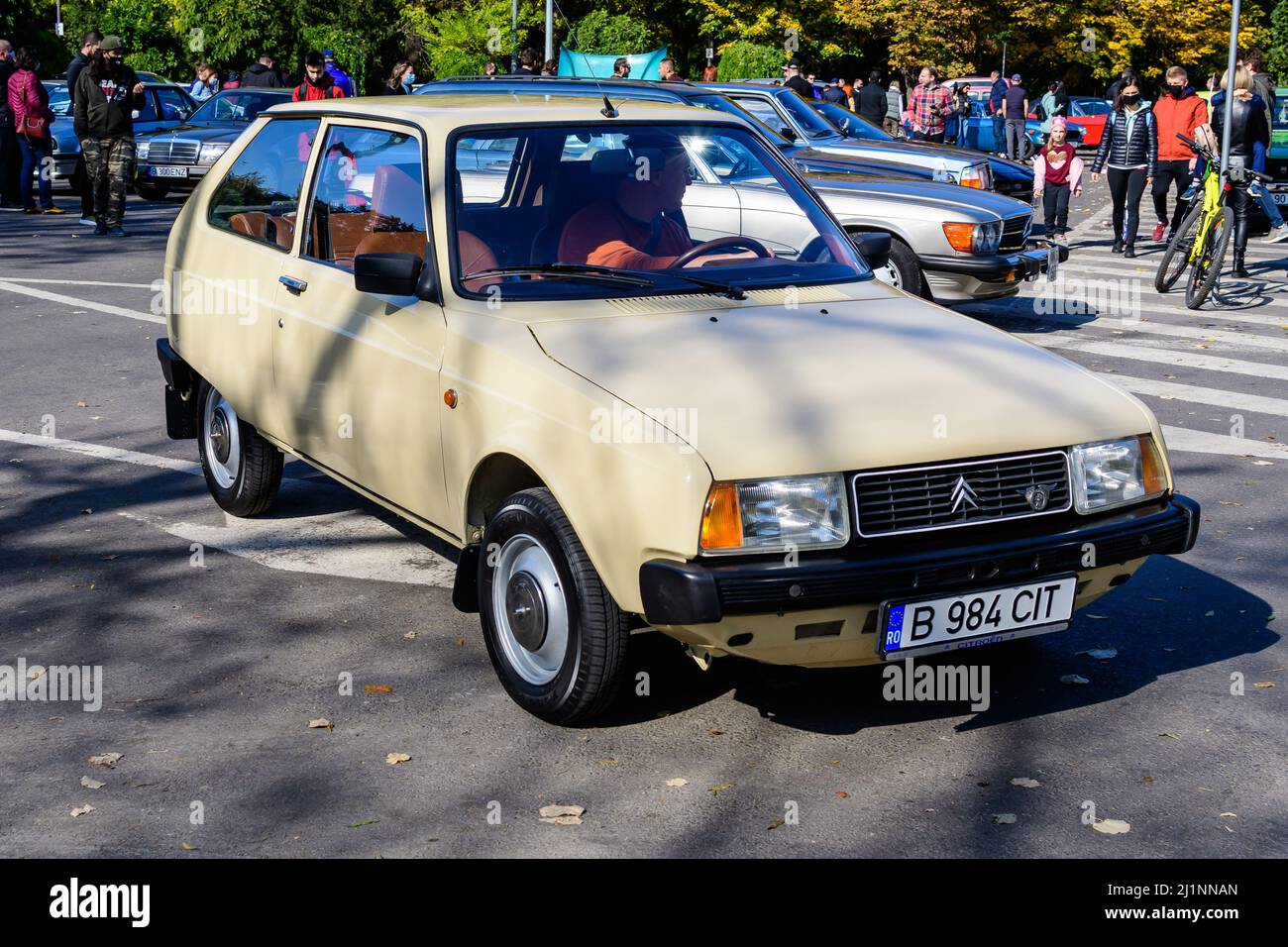 Bucharest, Romania, 24 October 2021: One vivid yellow Citroen French vintage car in traffic in a street at an event for vintage cars collections, in a Stock Photo