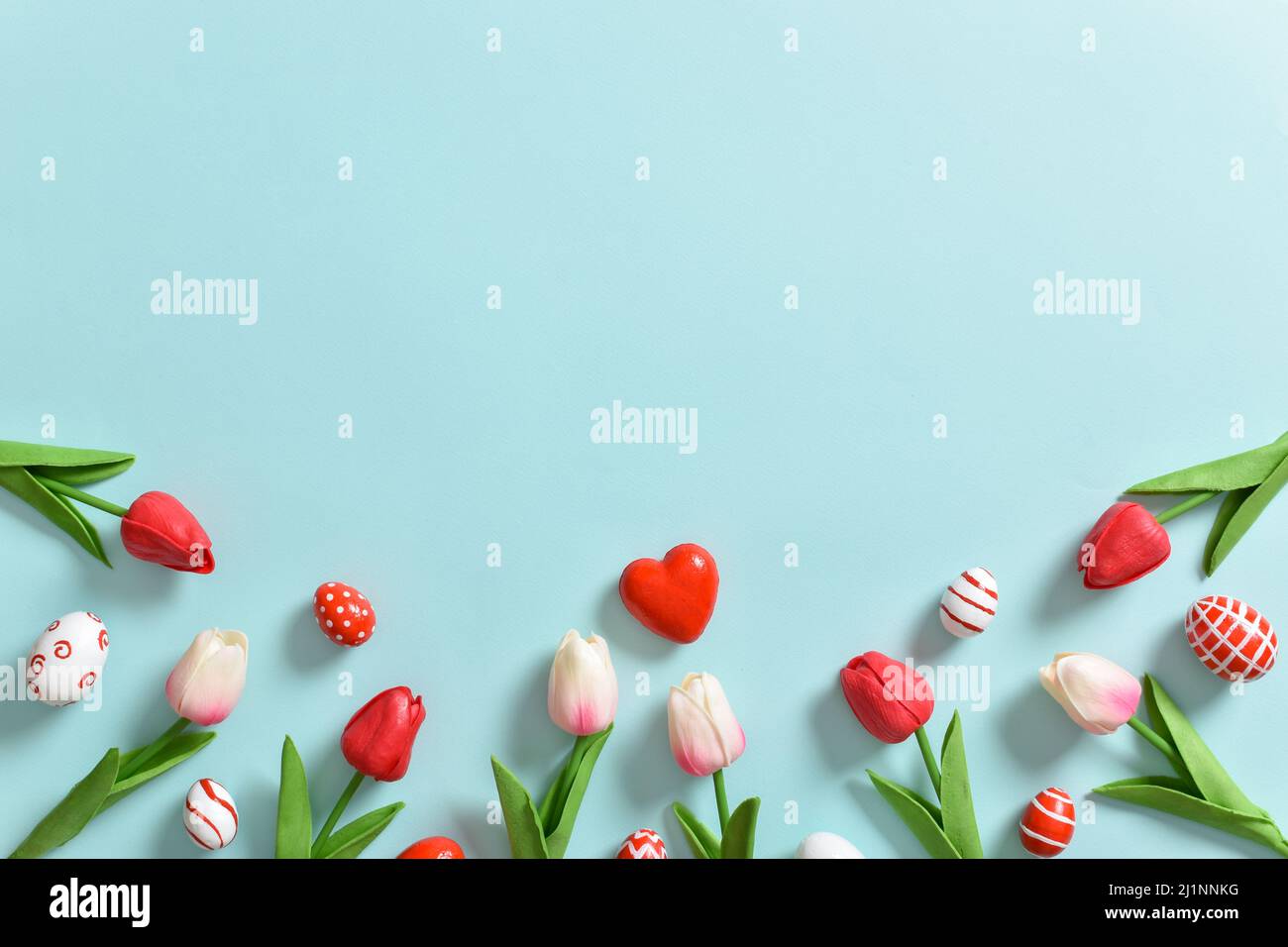 Background with red tulips and painted Easter eggs Stock Photo - Alamy