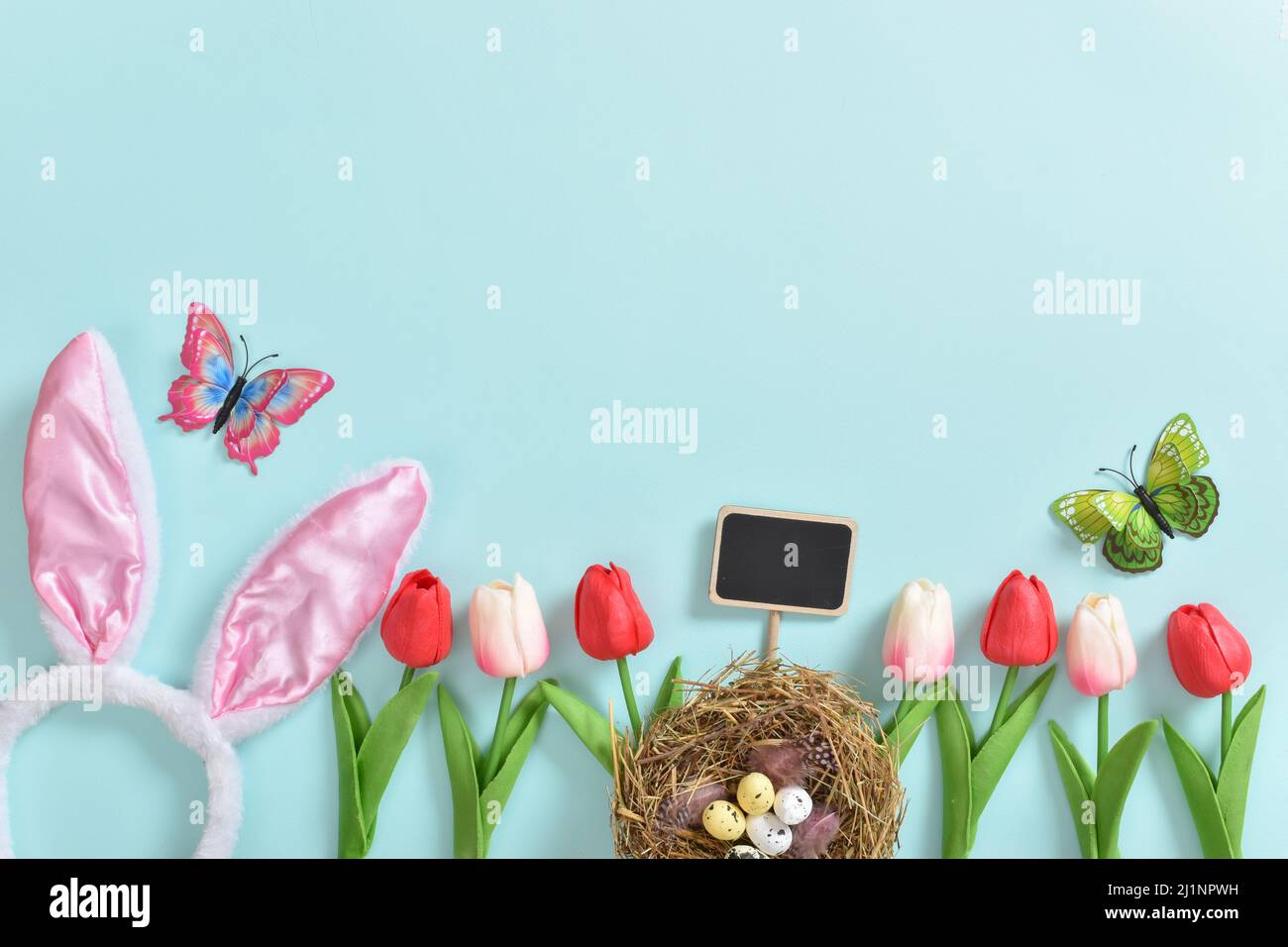 Background with rabbit ears, Easter eggs and tulip flowers Stock Photo ...