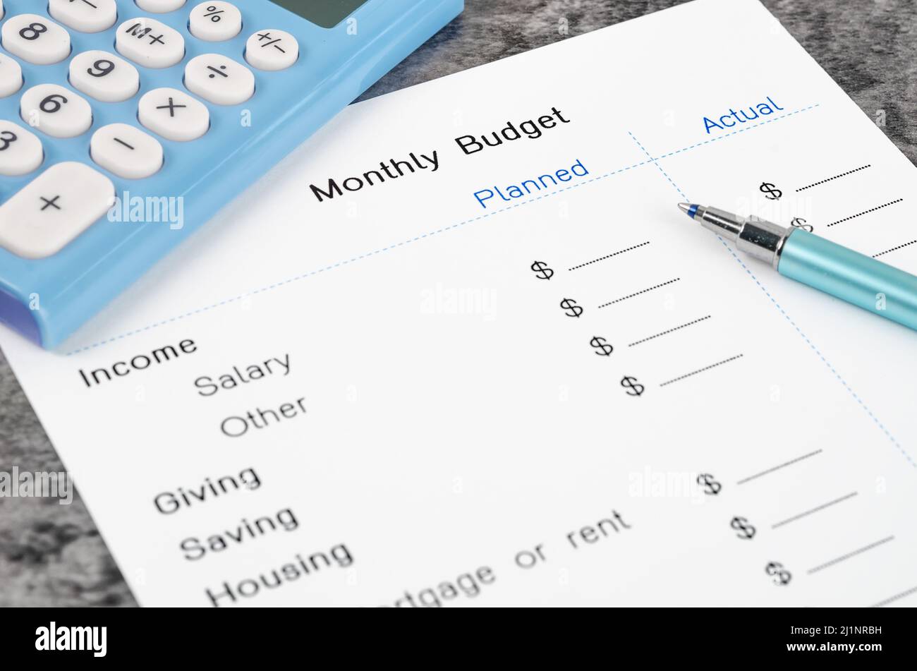 A print out of a monthly budget for your text with pen and calculator on wooden background. Stock Photo