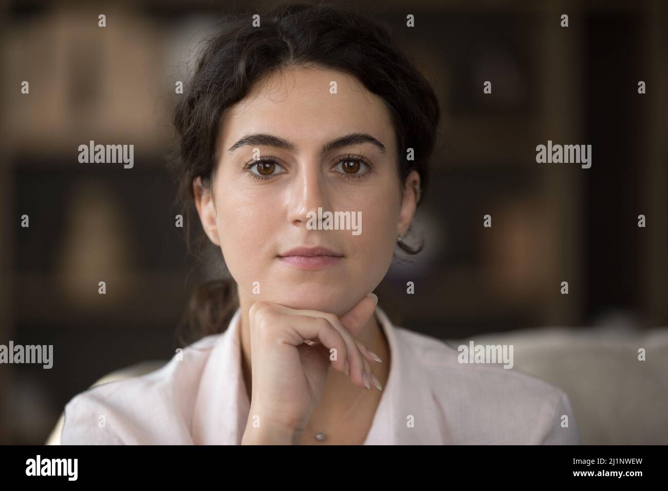Calm confident young Hispanic girl, millennial woman looking at camera Stock Photo