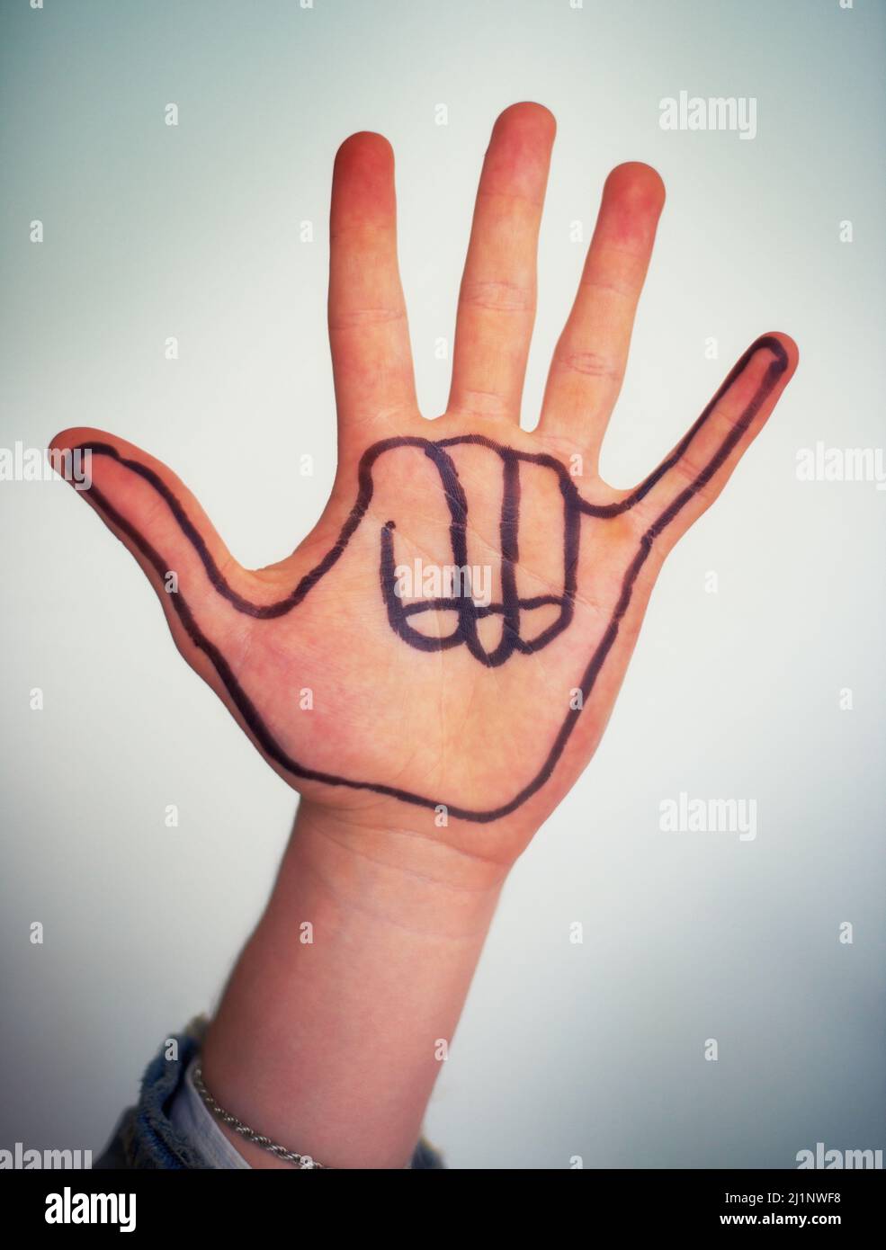 No worries. Cropped view of a male hand with a Hawaiian shaka gesture drawn on it. Stock Photo