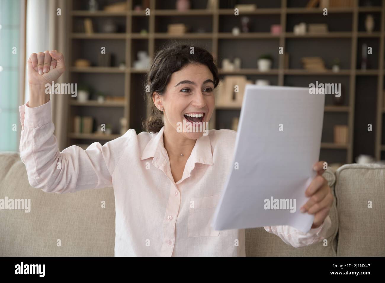 Overjoyed cheerful student girl getting good news mail, Stock Photo