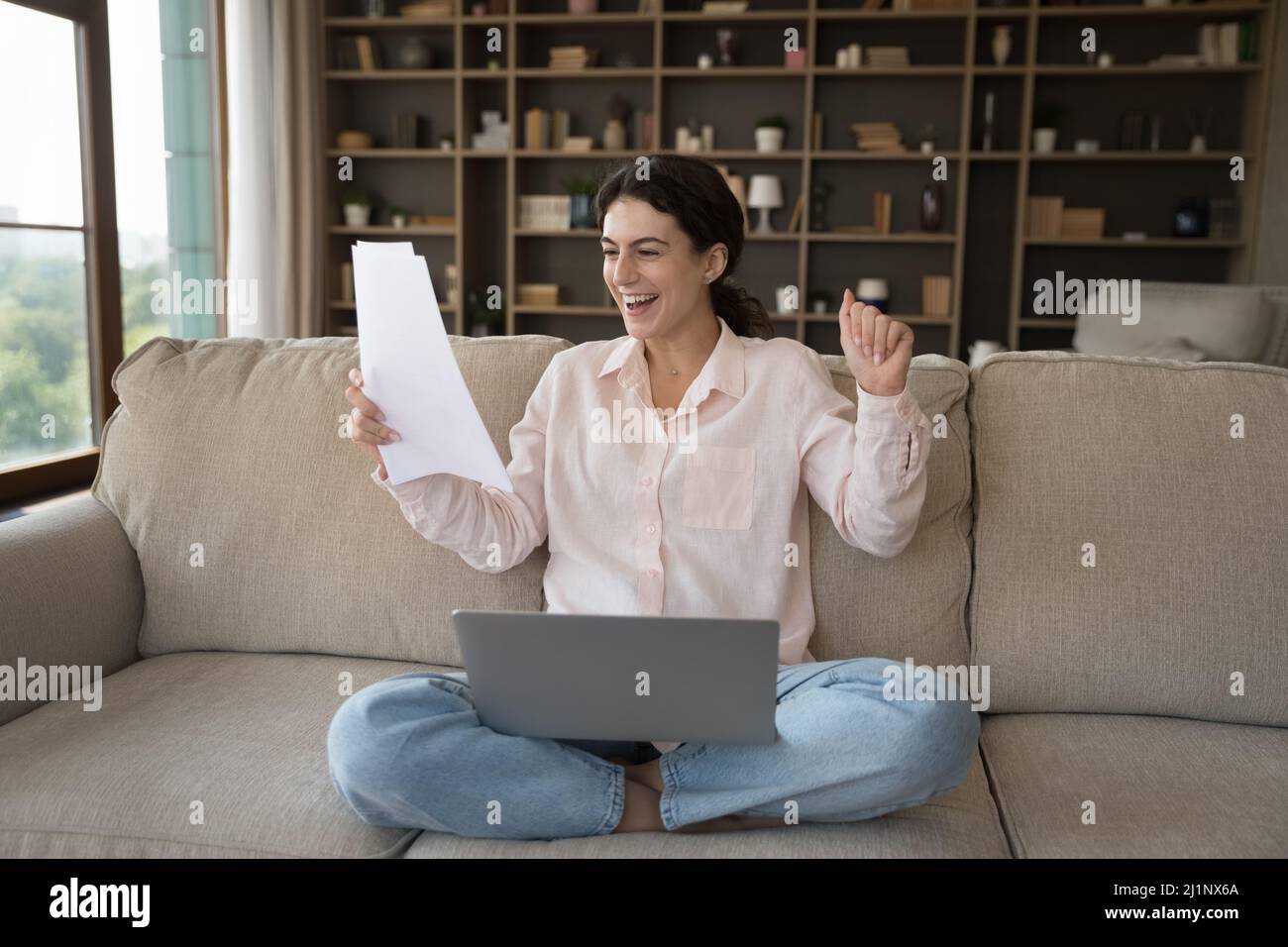 Joyful excited student girl getting admission letter from school Stock Photo