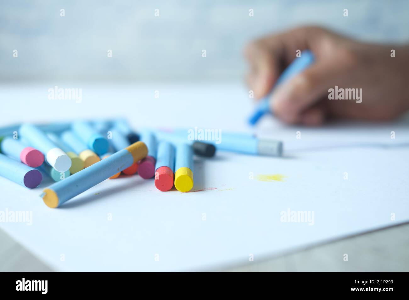 Color pencils on yellow papers on table  Stock Photo