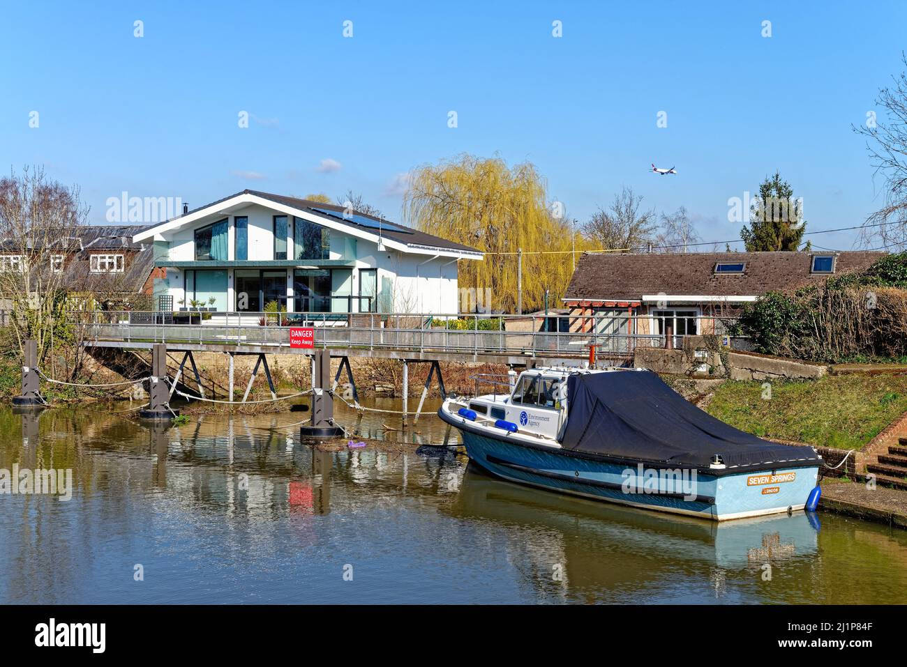 A modern designed home by the New Cut on Ham Island next to  the River Thames at Old Windsor on a sunny spring day Berkshire England UK Stock Photo