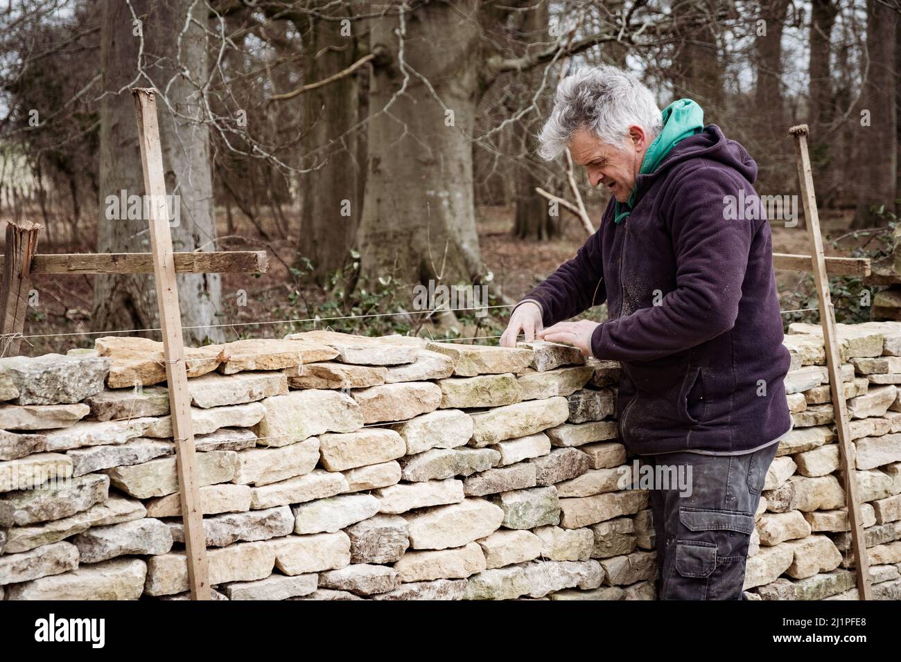 A Dry Stone Waller - Dry Stone walling in the Cotswolds Stock Photo
