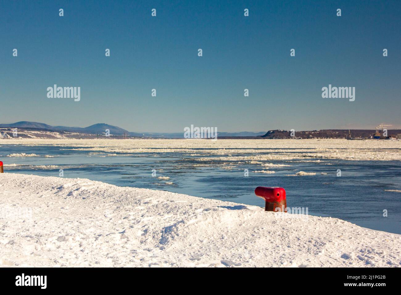 Quebec port in winter. Floating ice on St-Lawrence river. Stock Photo
