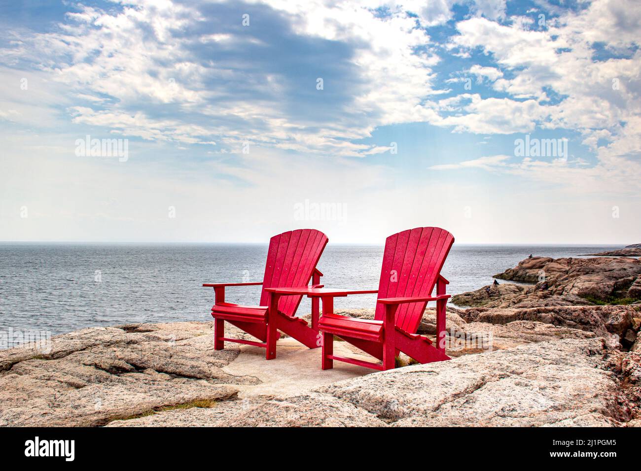 Adirondack red chairs near Tadoussac, Quebec, Canada for whales watching in the St-Lawrence river Stock Photo