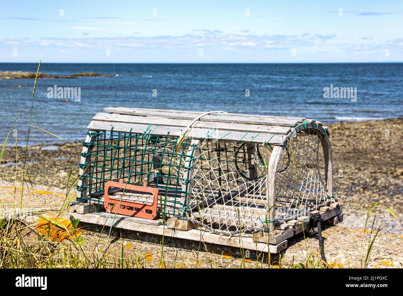 Lobster trap on the edge of St-Lawrence river, Quebec, Canada Stock Photo