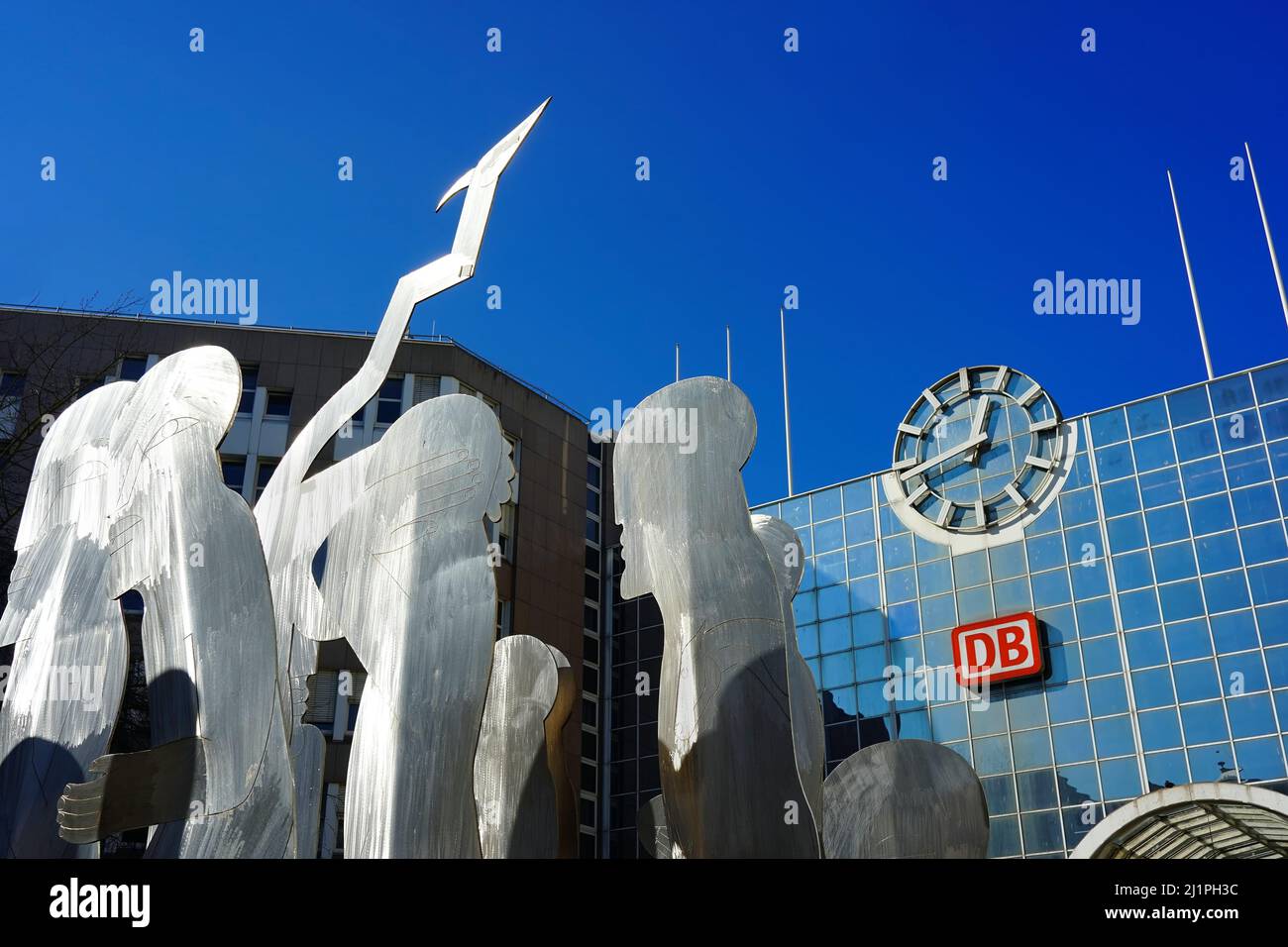 Modern art at the Düsseldorf Central Station: Stainless steel silhouette figures by the artist Horst Antes, reflecting the sunlight. Stock Photo