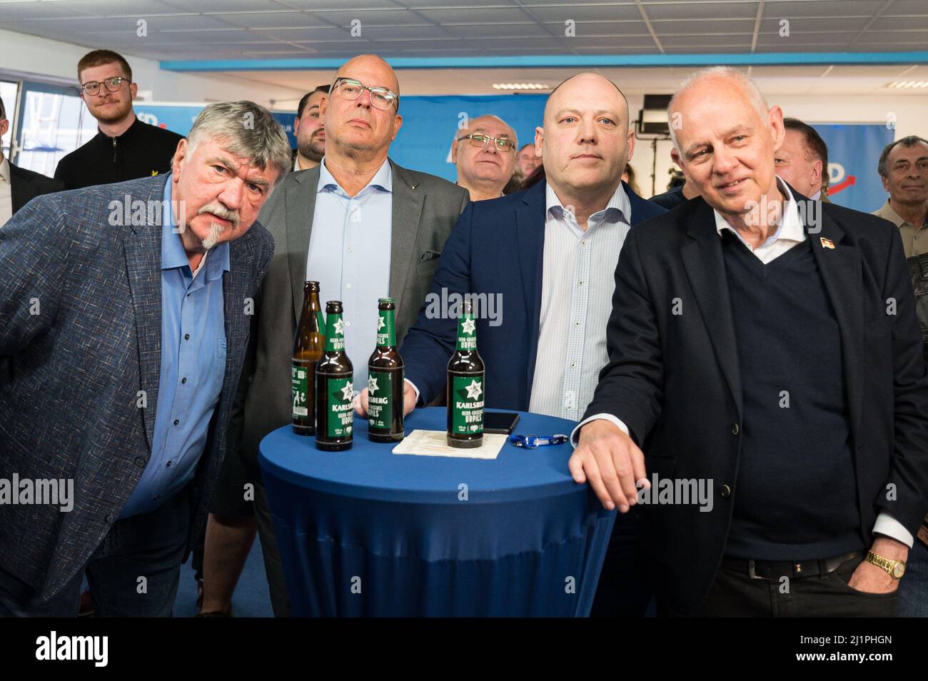27 March 2022, Saarland, Saarbrücken: Johann Jank (l-r), chairman of the AfD community association in Gersheim, Christian Wirth, state chairman of the AfD Saarland, Joachim Paul, deputy chairman of the AfD parliamentary group in the state parliament of Rhineland-Palatinate, and Rudolf Müller, chairman of the AfD district association Saarbrücken-Stadt, watch the forecasts for the state election with AfD supporters at the election party. More than 750,000 citizens were called to vote in the state election in Saarland. Photo: Oliver Dietze/dpa Stock Photo