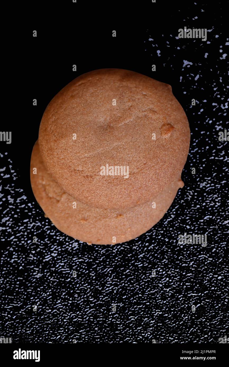 closeup the pair of brown chocolate biscuit over out of focus black ...