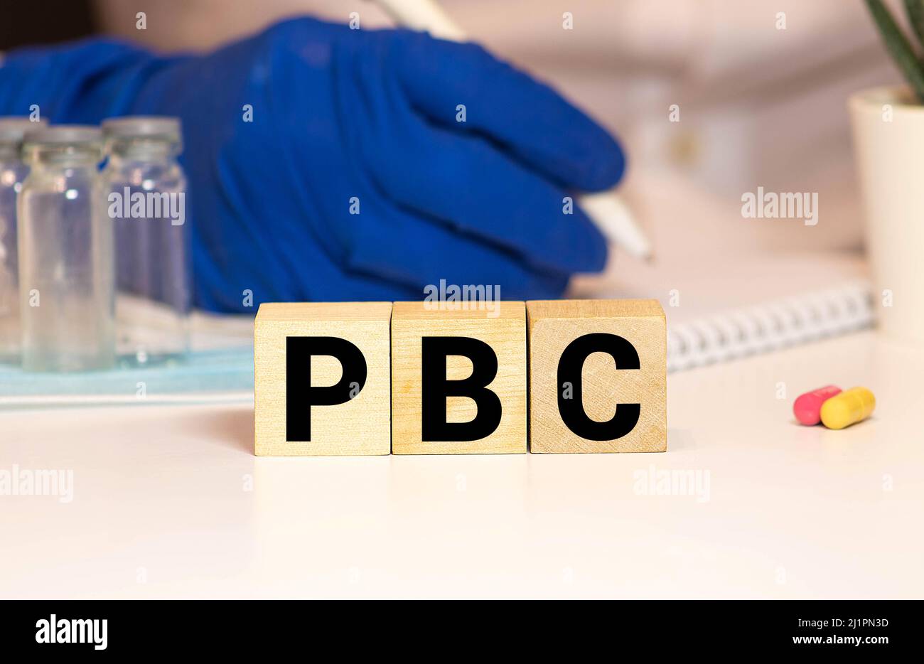 Primary Biliary Cirrhosis PBC word, medical term word with medical concepts in blackboard and medical equipment background. Stock Photo