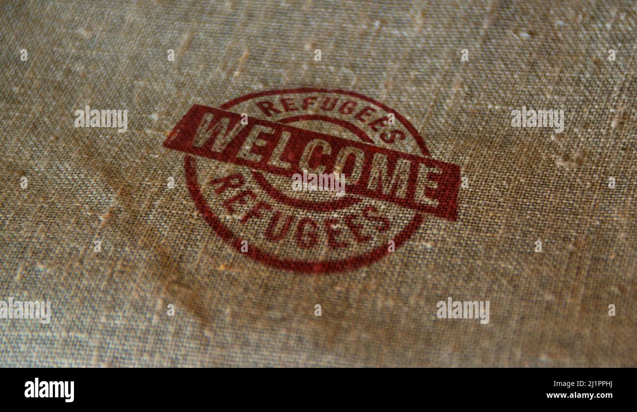 Refugees Welcome stamp printed on linen sack. Migration and humanitarian aid during the crisis concept. Stock Photo