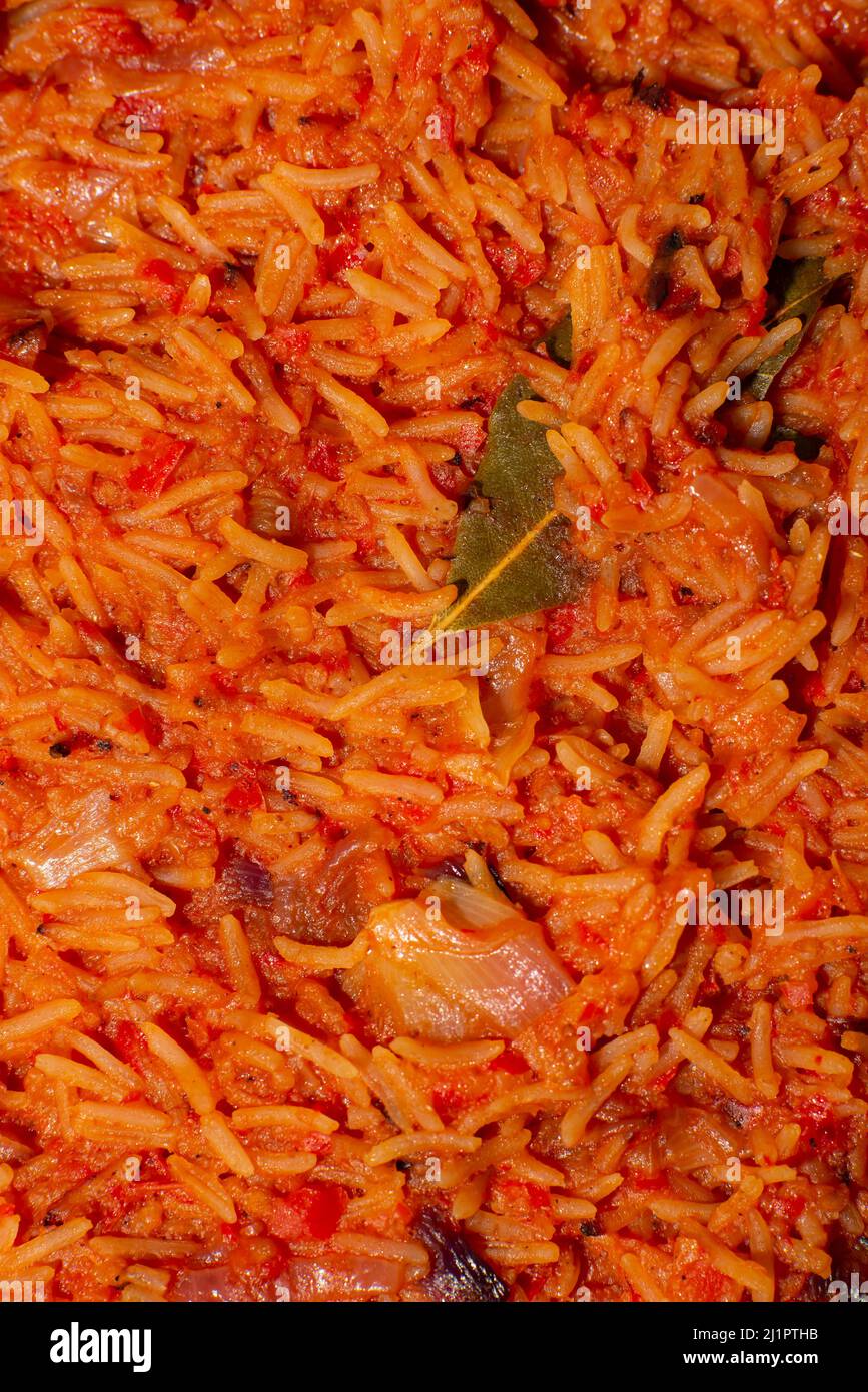 Jollof rice closeup. Background of rice cooked in tomato paste with