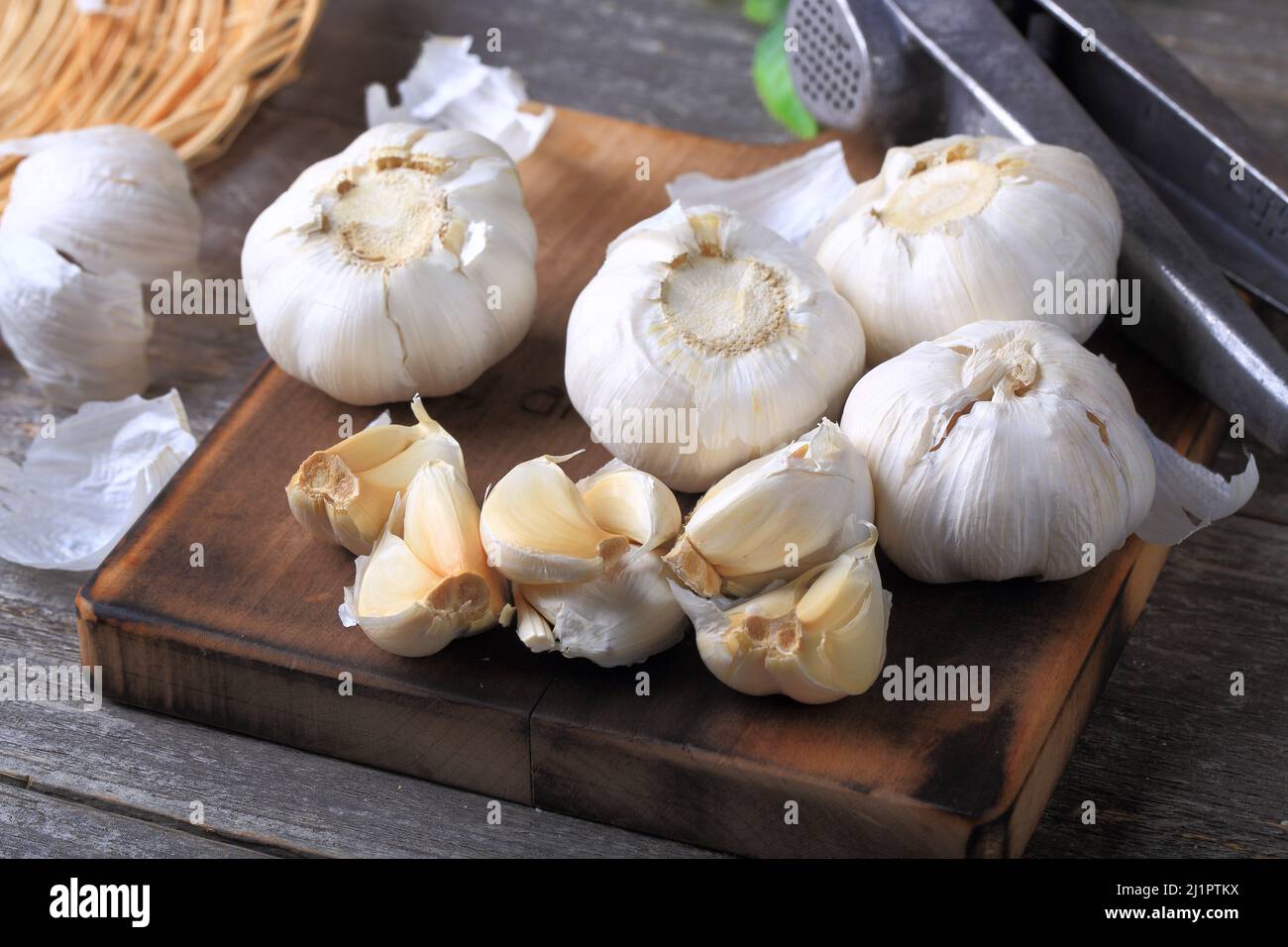 Garlic Cloves and Bulb on Wooden Background Stock Photo - Alamy
