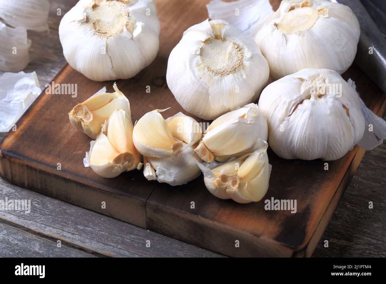 Garlic Cloves and Bulb on Wooden Background Stock Photo - Alamy