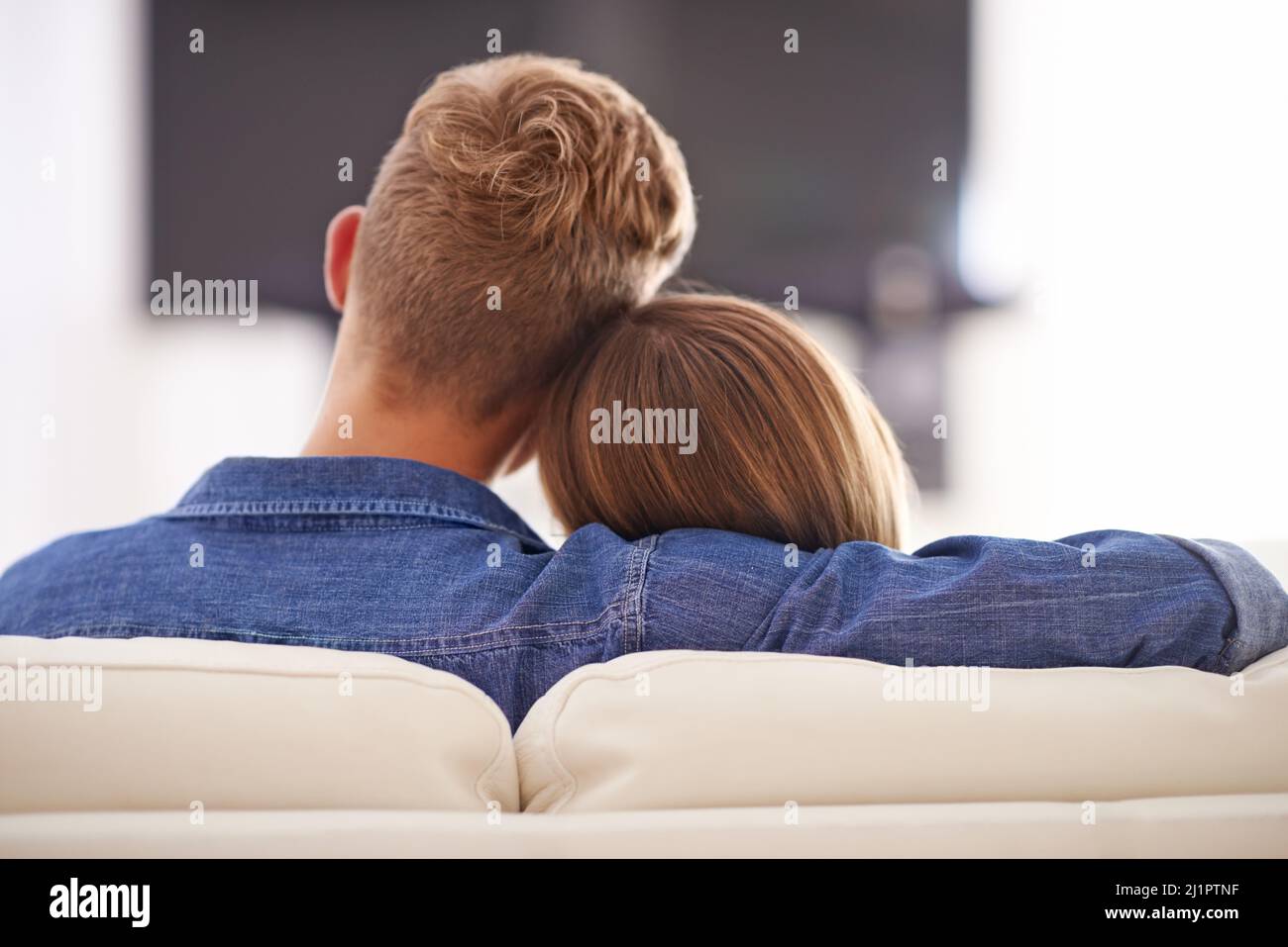 Its the little things that count. Cropped shot of a young couple sitting on the couch together. Stock Photo