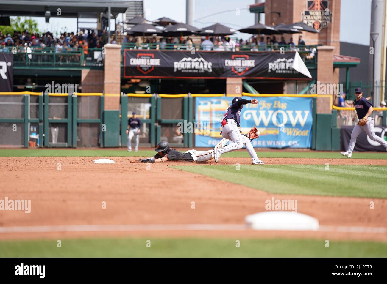 Scottsdale, United States. 25th Mar, 2022. Cleveland Guardians player hands  off equipment to the San Francisco Giants batboy during a MLB spring  training baseball game on Friday Mar. 25, 2022, at Scottsdale