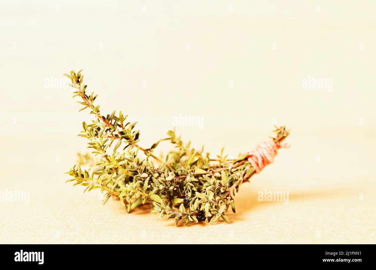 Bunch of fresh thymus on light wooden background, culinary herb Stock Photo