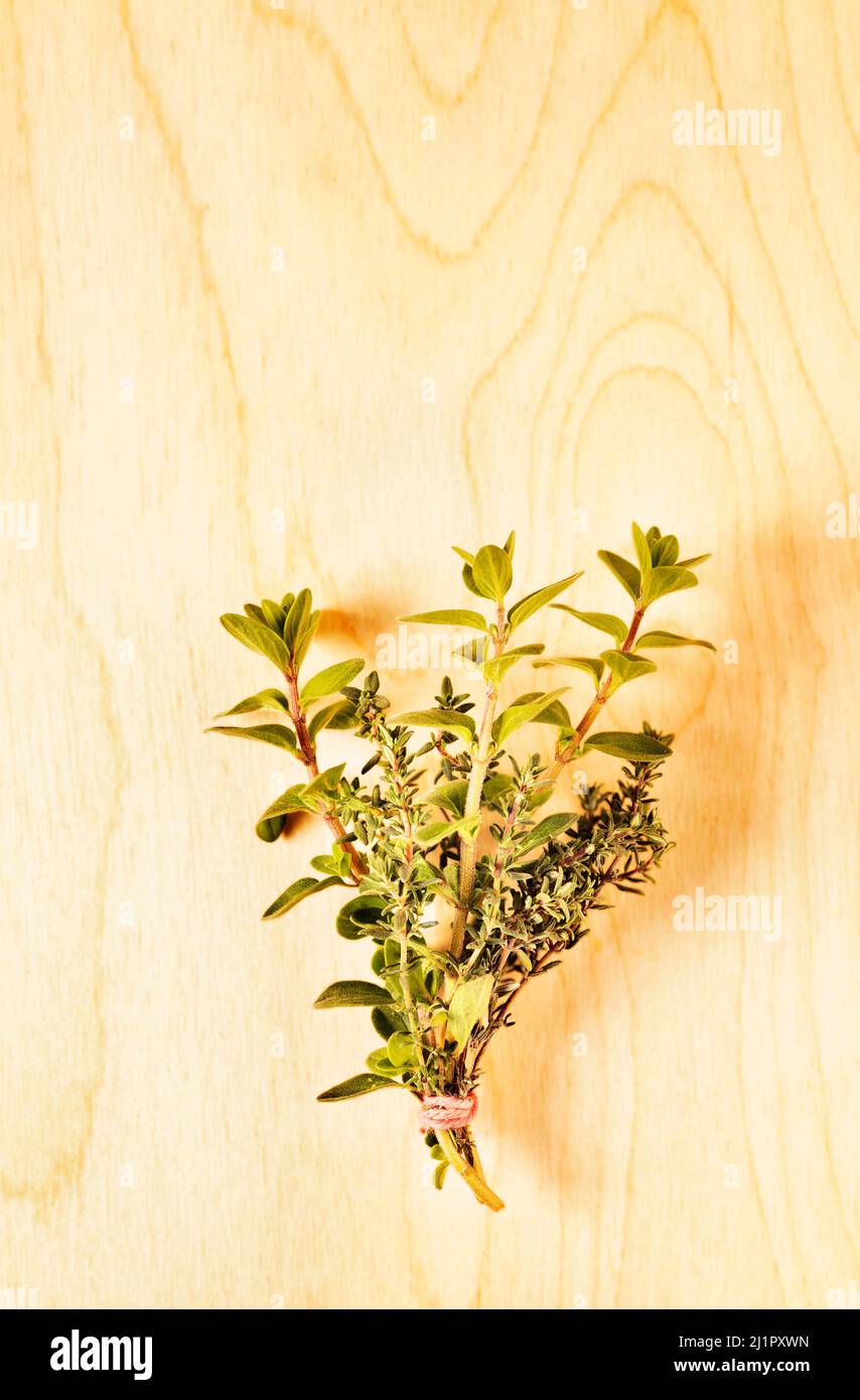 Bunch of fresh thymus and origanum on wooden background, culinary herbs Stock Photo