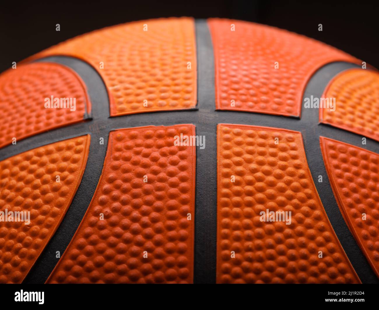 Macro shot. Details of a basketball ball on a black background. Sports