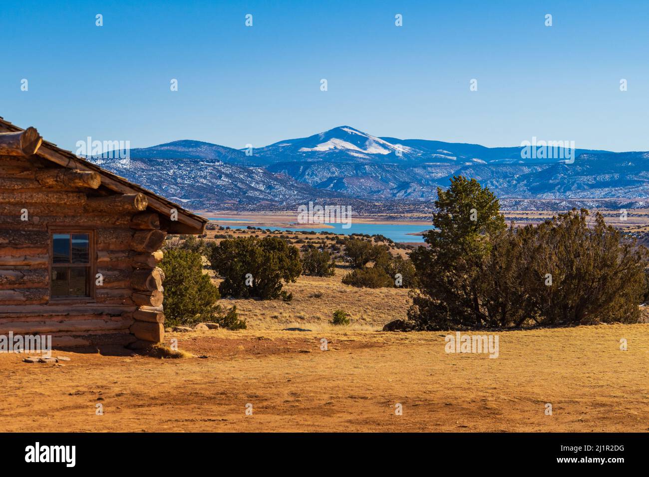 view from old cabin at Ghost Ranch of Abiquiu Lake and snowy mountain landscape Stock Photo