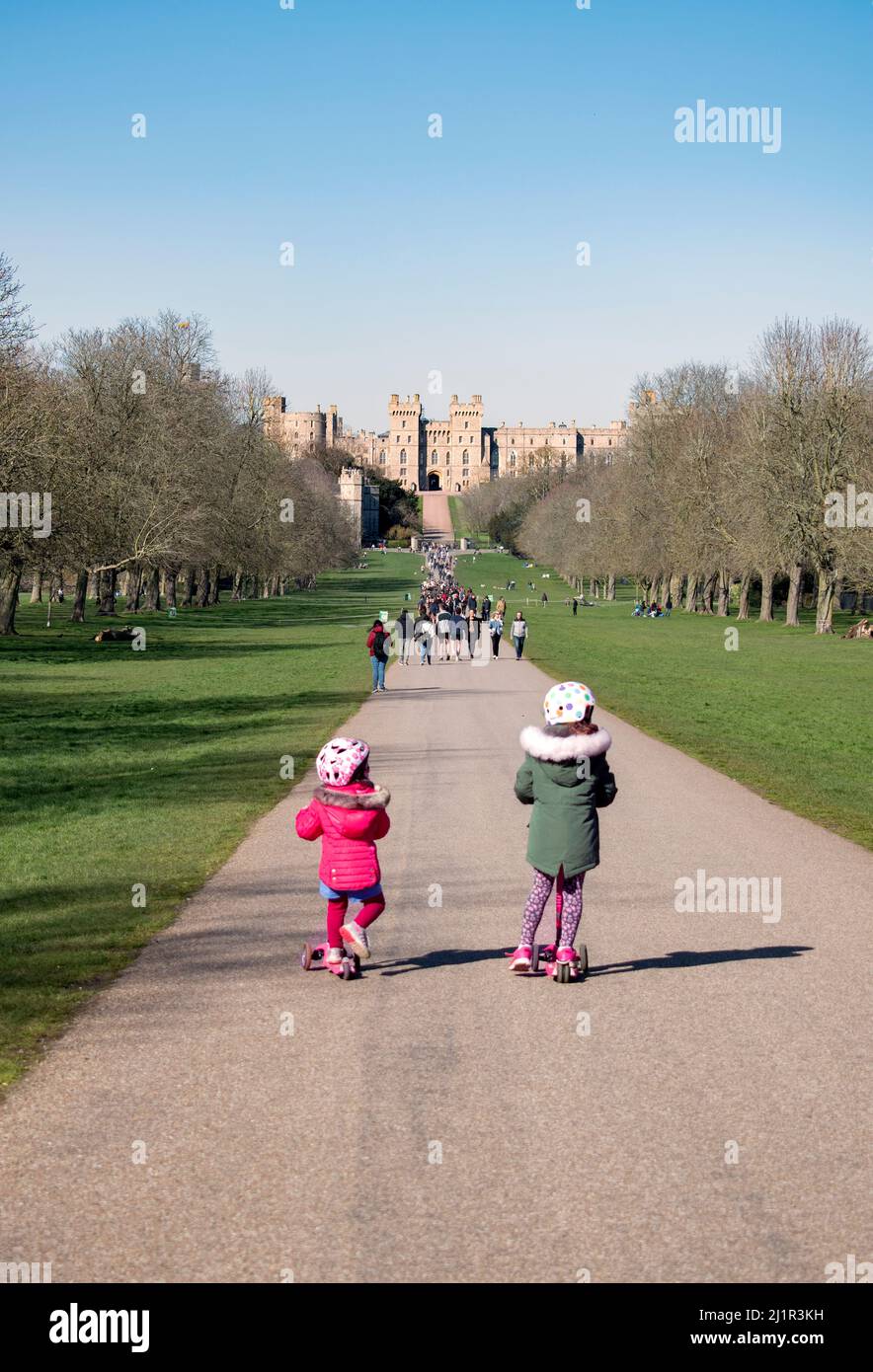 March 19th 2022 - Windsor, UK: Children riding scooters on The Long Walk at Windsor Castle Stock Photo