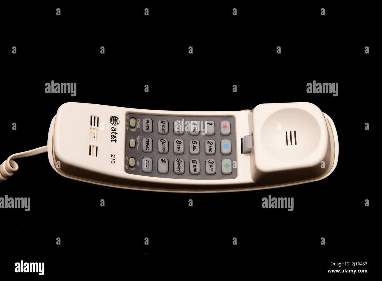 A white AT&T corded trimline touchtone landline telephone isolated on black Stock Photo
