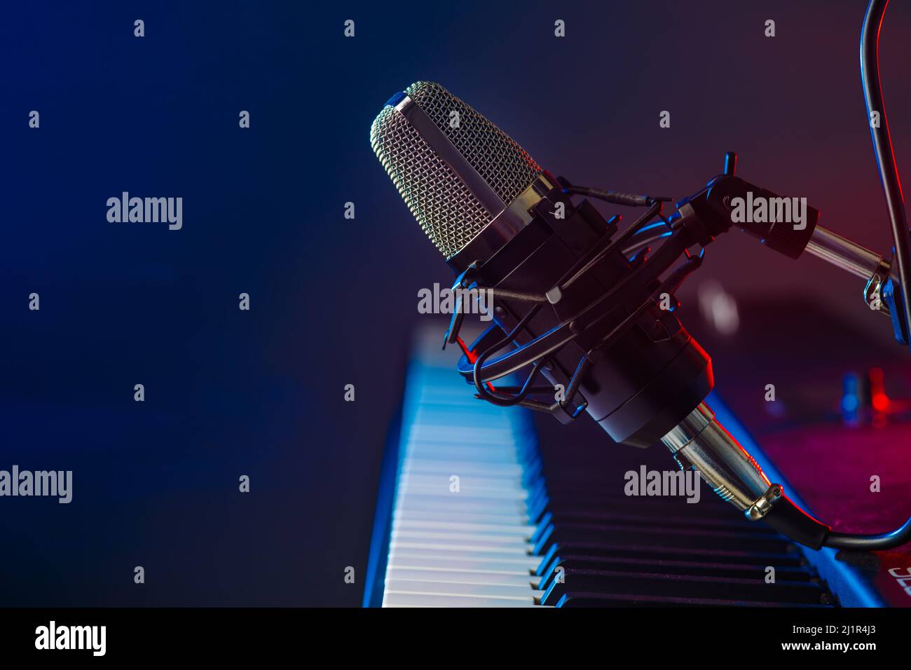 Musical instrument midi keyboard and microphone on a blue background