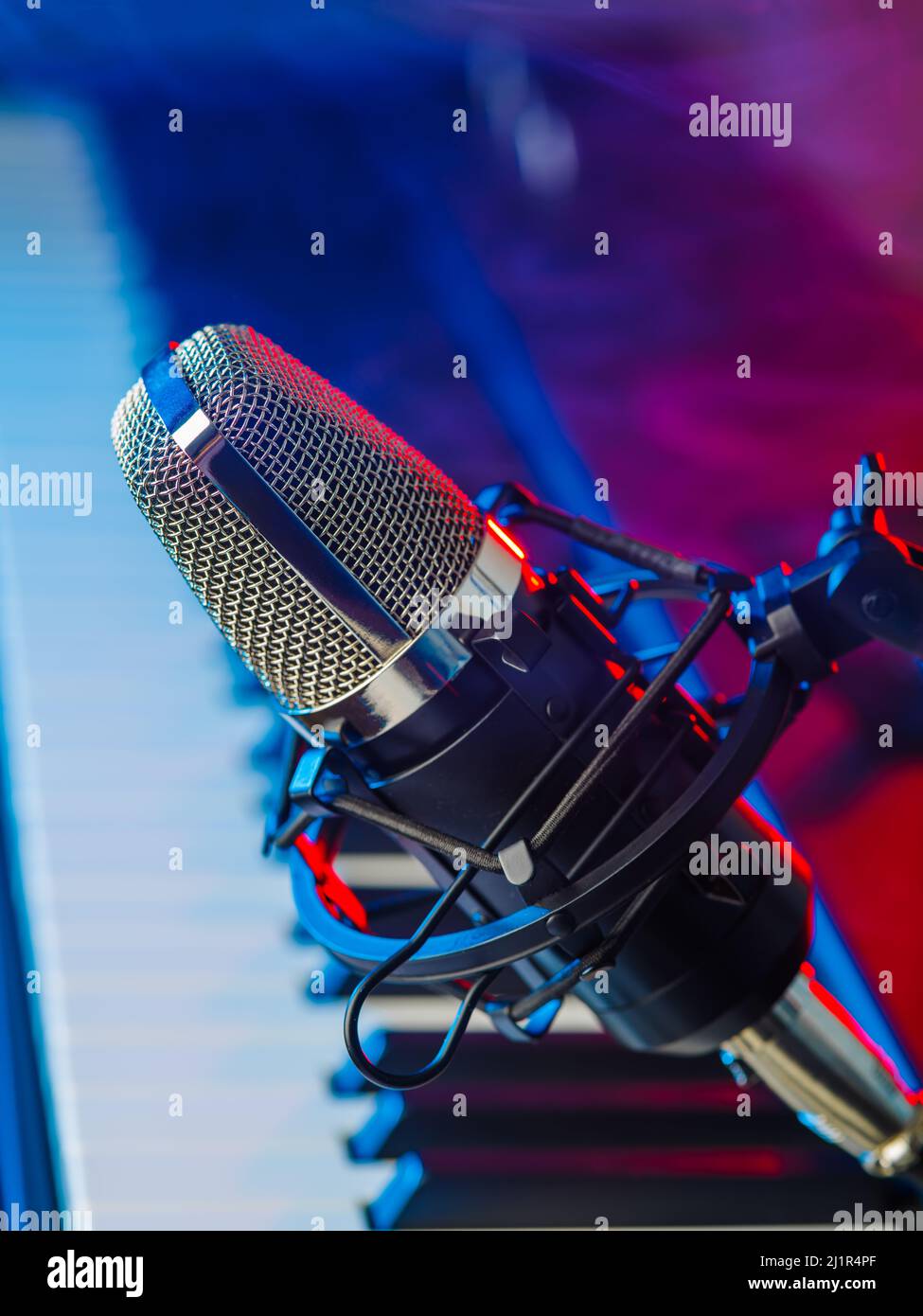 Professional microphone and musical instrument - midi keyboard on a  multi-colored background. Music, singing, karaoke, concert, nightclub,  recording s Stock Photo - Alamy