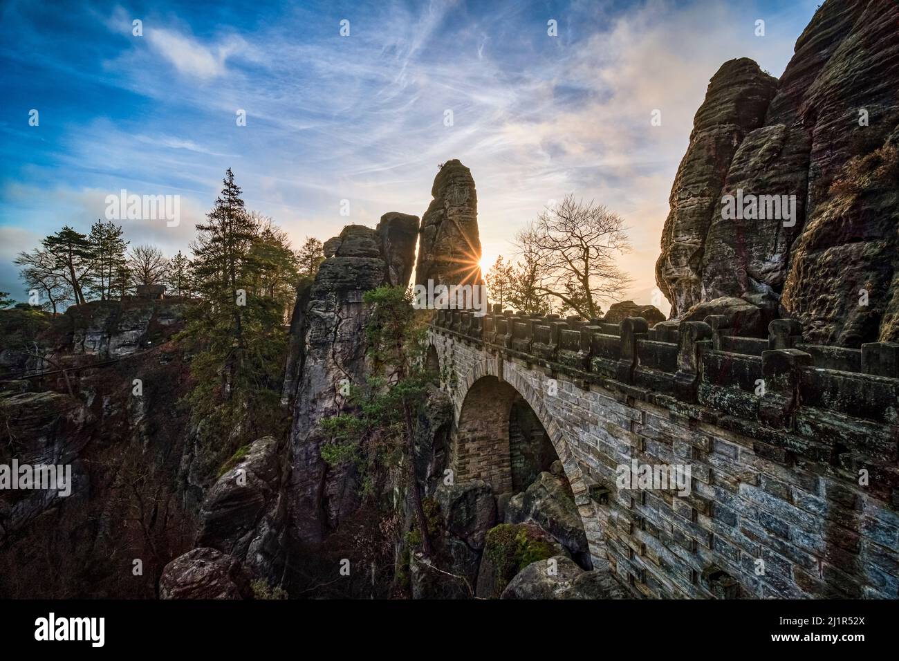 The bridge of the rock formation Bastei in Rathen area of the Saxon Switzerland National Park at sunrise. Stock Photo