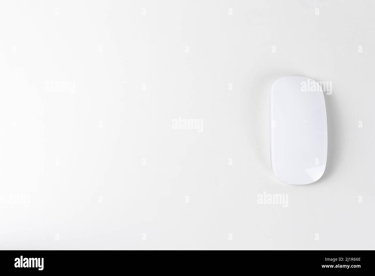 White wireless mouse on white backgroung, copy space Stock Photo