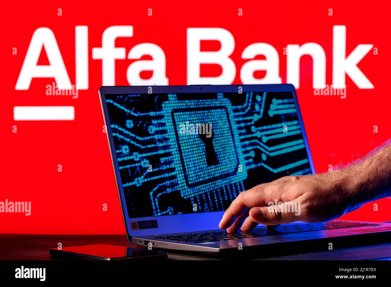 Laptop with lock symbol on screen on background of Alfa Bank logo ...