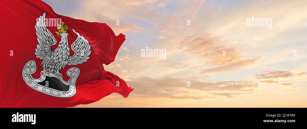 flag of Polish Land Forces , Poland at cloudy sky background on sunset, panoramic view. Polish travel and patriot concept. copy space for wide banner. Stock Photo