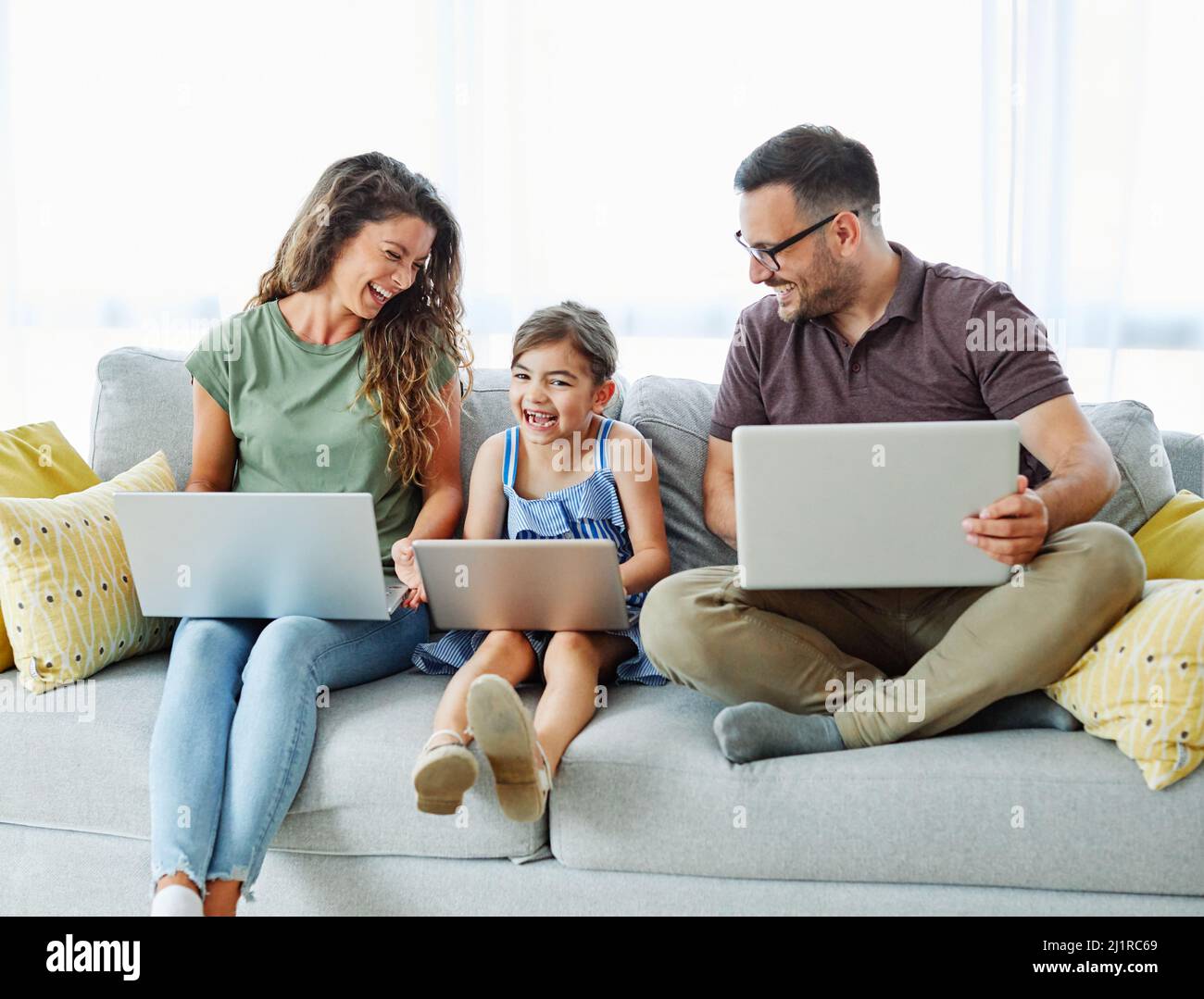 laptop computer education mother father child daughter girl familiy childhood home technology parent Stock Photo
