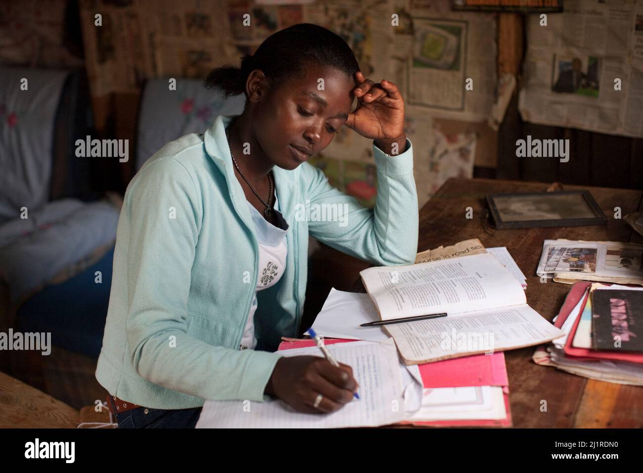 Prisca, 23,  now a student, doing college work at home. She is an AIDs orphan and head of her household of three younger children, Meru, Kenya. Stock Photo