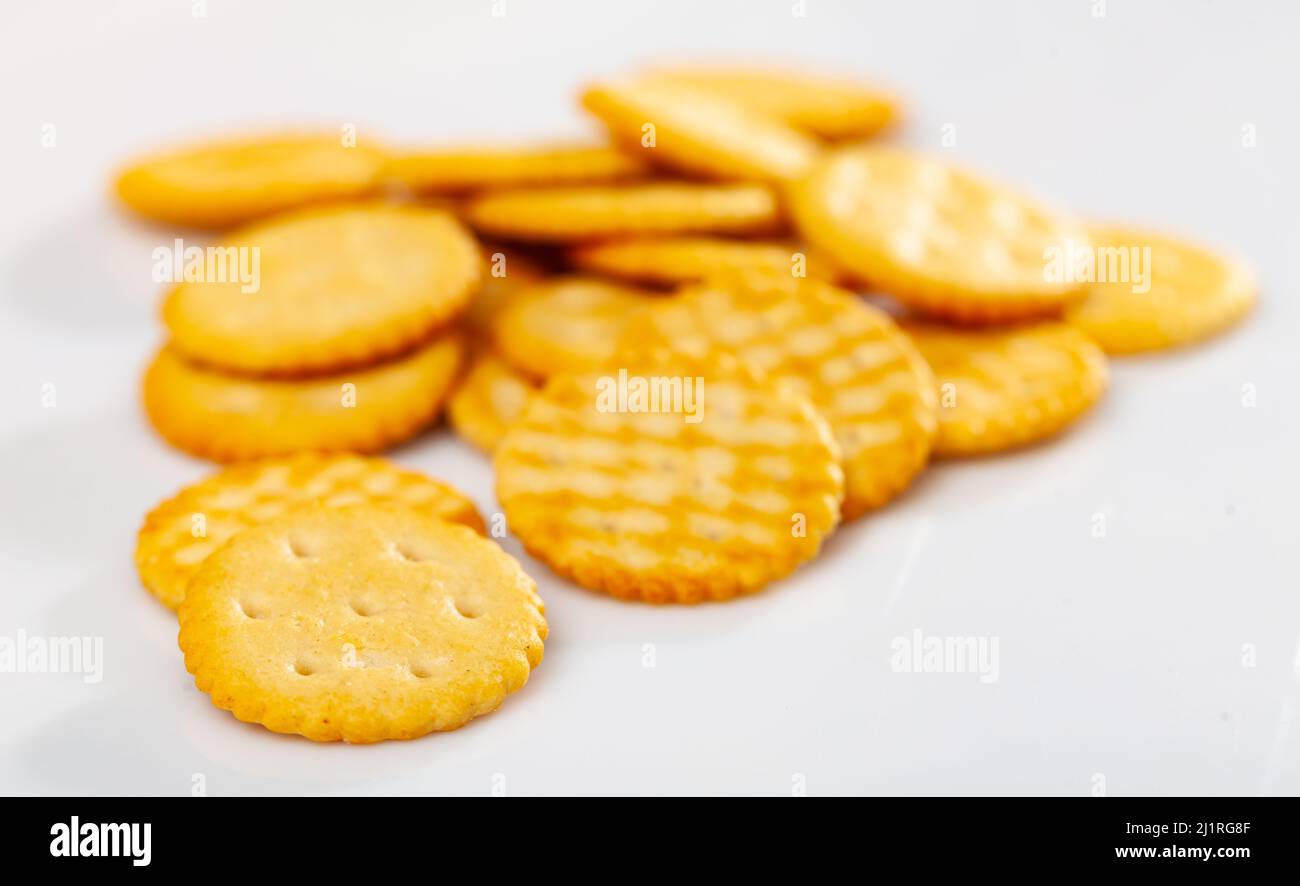 Heap of crispy salted crackers on white background Stock Photo Alamy