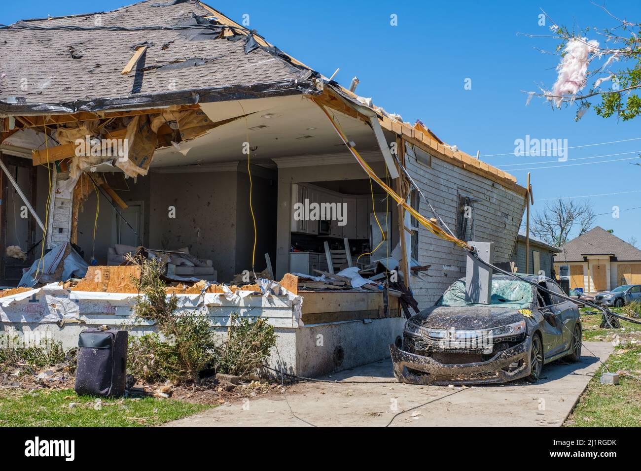 ARABI, LA, USA - MARCH 26, 2022: Roof mangled, front of house torn off and circuit panel landed on the windshield after the tornado of March 22, 2022 Stock Photo