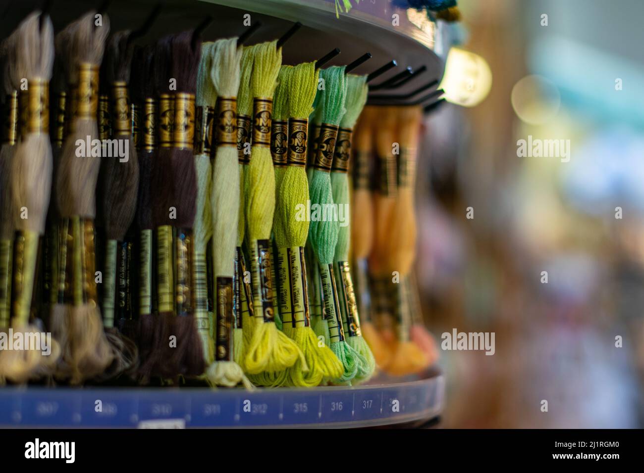 Thame,UK-Sept 2021: Various colors moulin threads hanging on store display, embroidery thread mouline for hobby and craft, popular for knotting Stock Photo