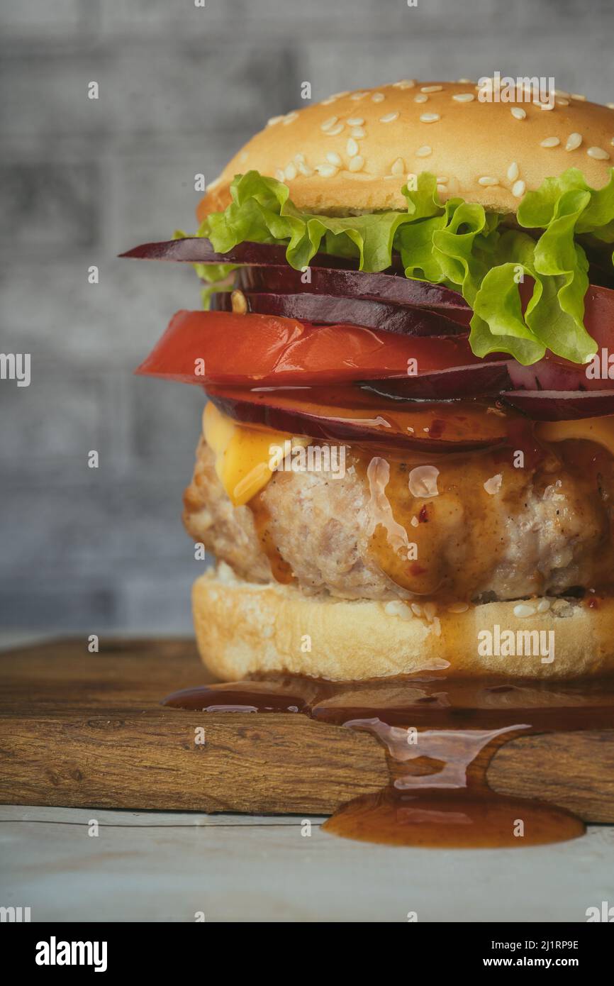 Healthy vegetarian meat free burgers on round chopping board with vegetables  and spinach on light background Stock Photo - Alamy